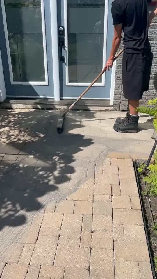 Cleaning pavers beside a pool